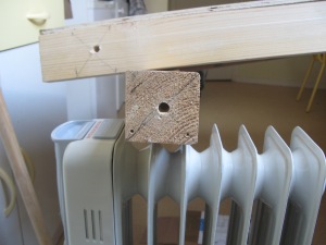 Make holes for the screw bolts which holds the top board on the legs. 